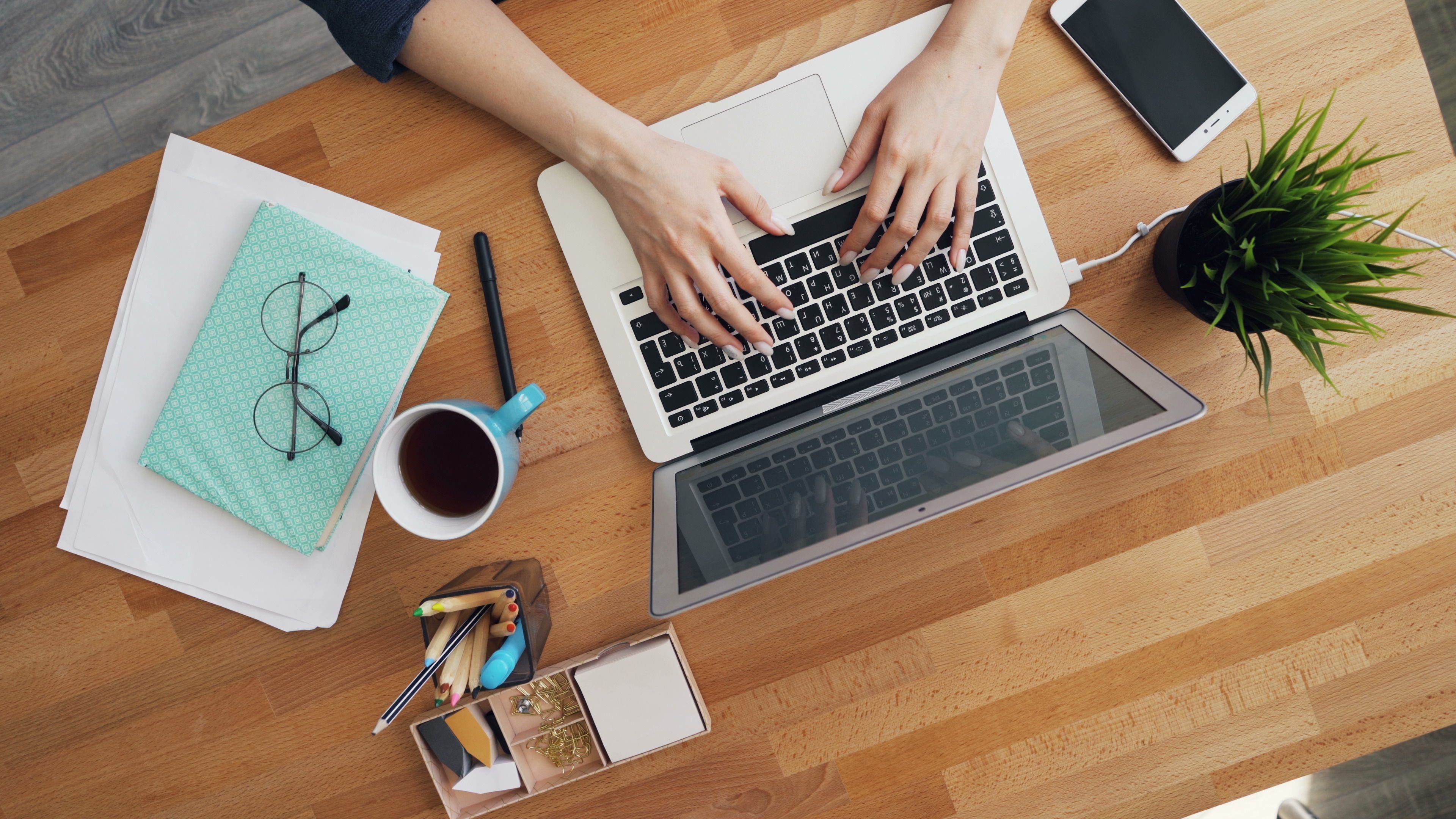 Person working on a laptop at a desk